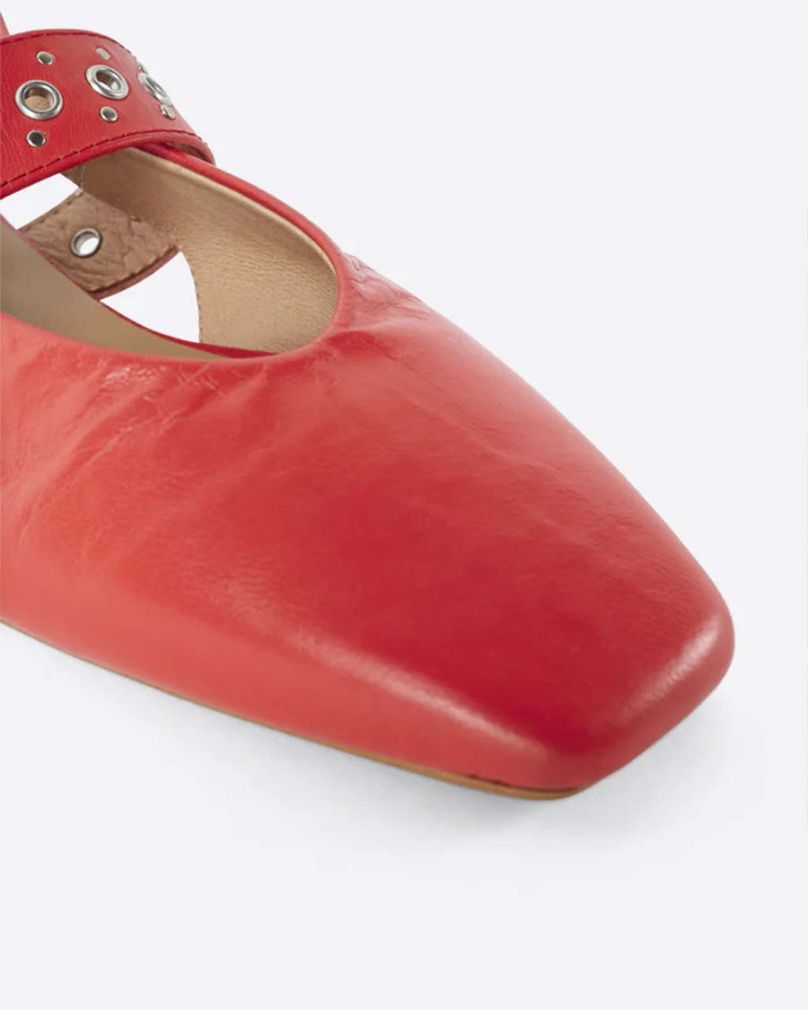 up close of cherry red slingback flat with large grommet buckle and square toe