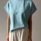 model wearing sky blue cotton tee with slight cap sleeves and white cotton balloon pants