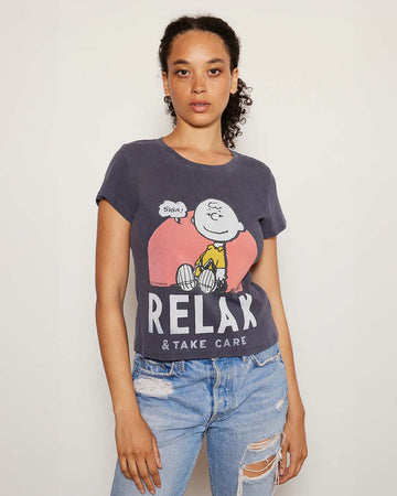 model wearing vintage black relaxed baby tee with charlie brown graphic 'relax & take care' typography