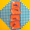 four pink and orange vertical stripe trinket trays with blue and red sardine on it
