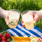 model holding clear pebbled cups with red snoopy in a bottle of root beer and 'SLURP' on the reverse side
