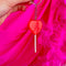 model holding red heart lolli keychain