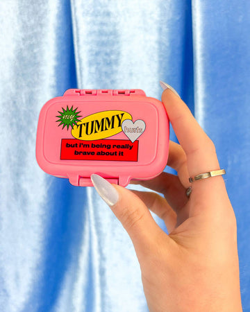 pink 'my tummy hurts, but i'm being really brave about it' pill case