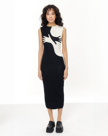 black and white knit midi dress with two abstract hands criss crossing on the front