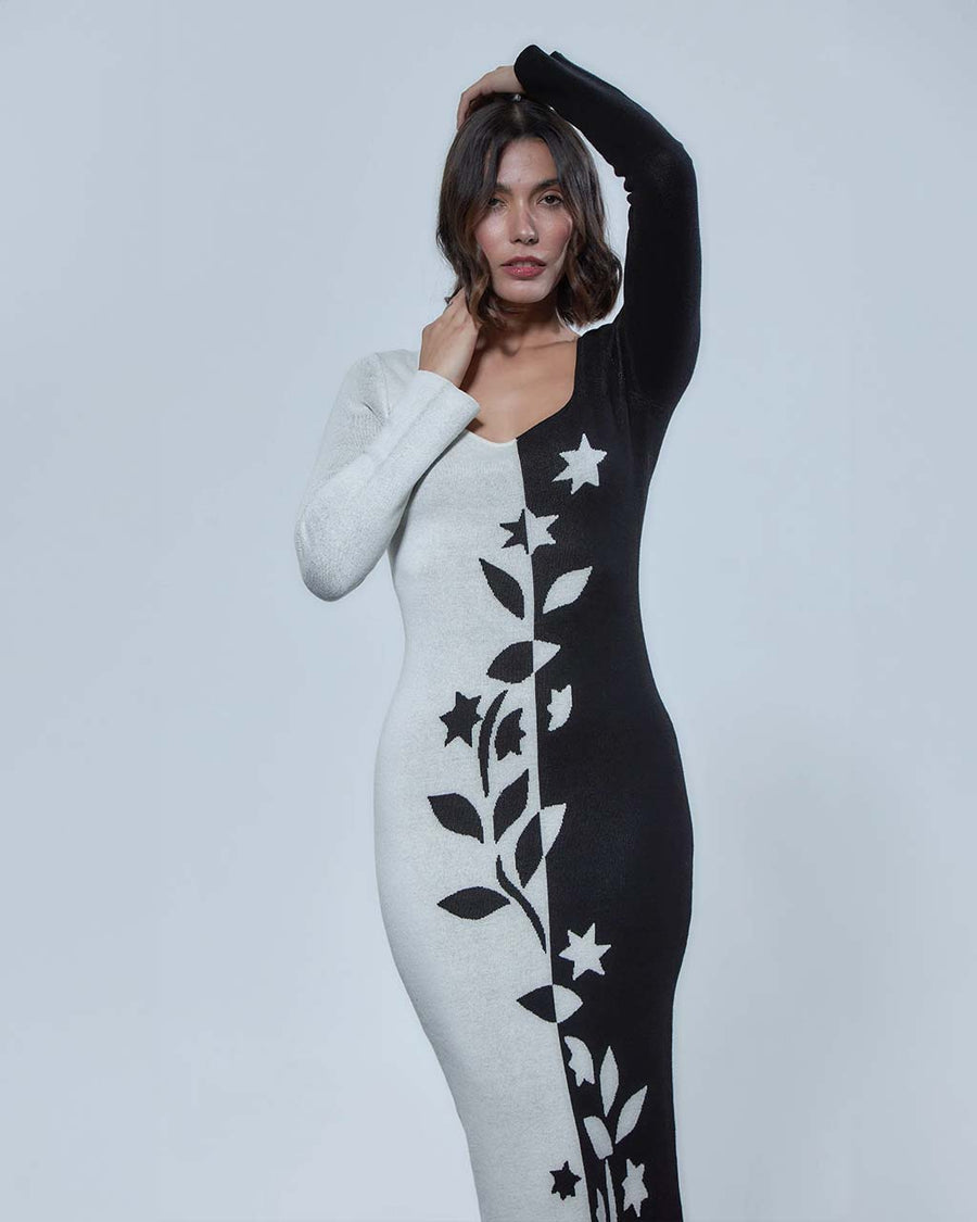up close of model wearing black and white split bodycon dress with vine and floral print down the center