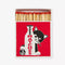 red tipped matches inside of red matchbox with black and white cat hiding behind a glass milk bottle