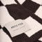up close of cream and espresso brown checkered blanket
