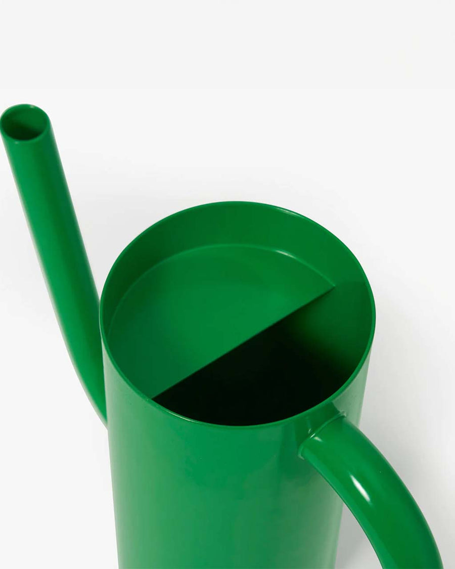 top view of small green watering can with elongated spout and handle
