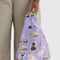 model holding purple baby baggu with various cats with ribbons tied around their necks