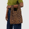 model carrying dark brown leopard baby baggu