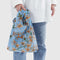 model holding blue baby baggu with yellow orchid prin