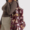 model wearing maroon big baggu with various dog print