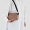 model wearing light brown baggu camera bag