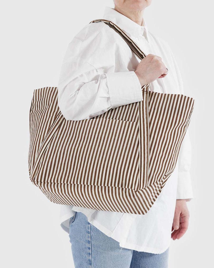 model wearing two tone brown vertical stripe cloud bag