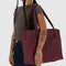 model carrying mahogany cloud carry on bag with two front pockets