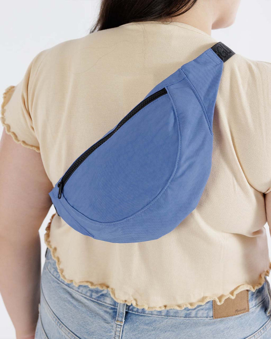 model wearing pansy blue baggu crescent fanny pack