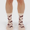 model wearing cream crew socks with brown horse silhouette print