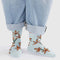 model wearing light blue crew socks with orange orchid print