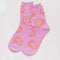 bright pink crew socks with orange smiley face design