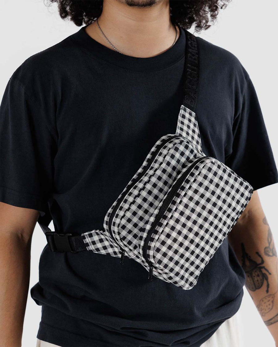 model wearing black and white gingham fanny pack