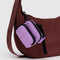 rose fanny pack keychain with black trim on a brown bag