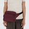 model wearing mahogany fanny pack with black trim across their waist