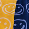 up close of set of two smiley hand towels: light blue and navy smiley and cream and yellow smiley