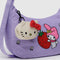 yellow kitty face bag charm on a purple crescent bag