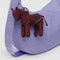 mahogany horse bag charm with lavender baggu on the back on a lavender bag