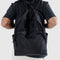 model wearing black large nylon backpack
