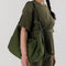 model wearing dark green large nylon crescent bag
