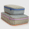 two large packing cube sets with various colorful stripe patterns and blue and lavender zippers