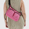 model wearing bright pink medium cargo crossbody bag