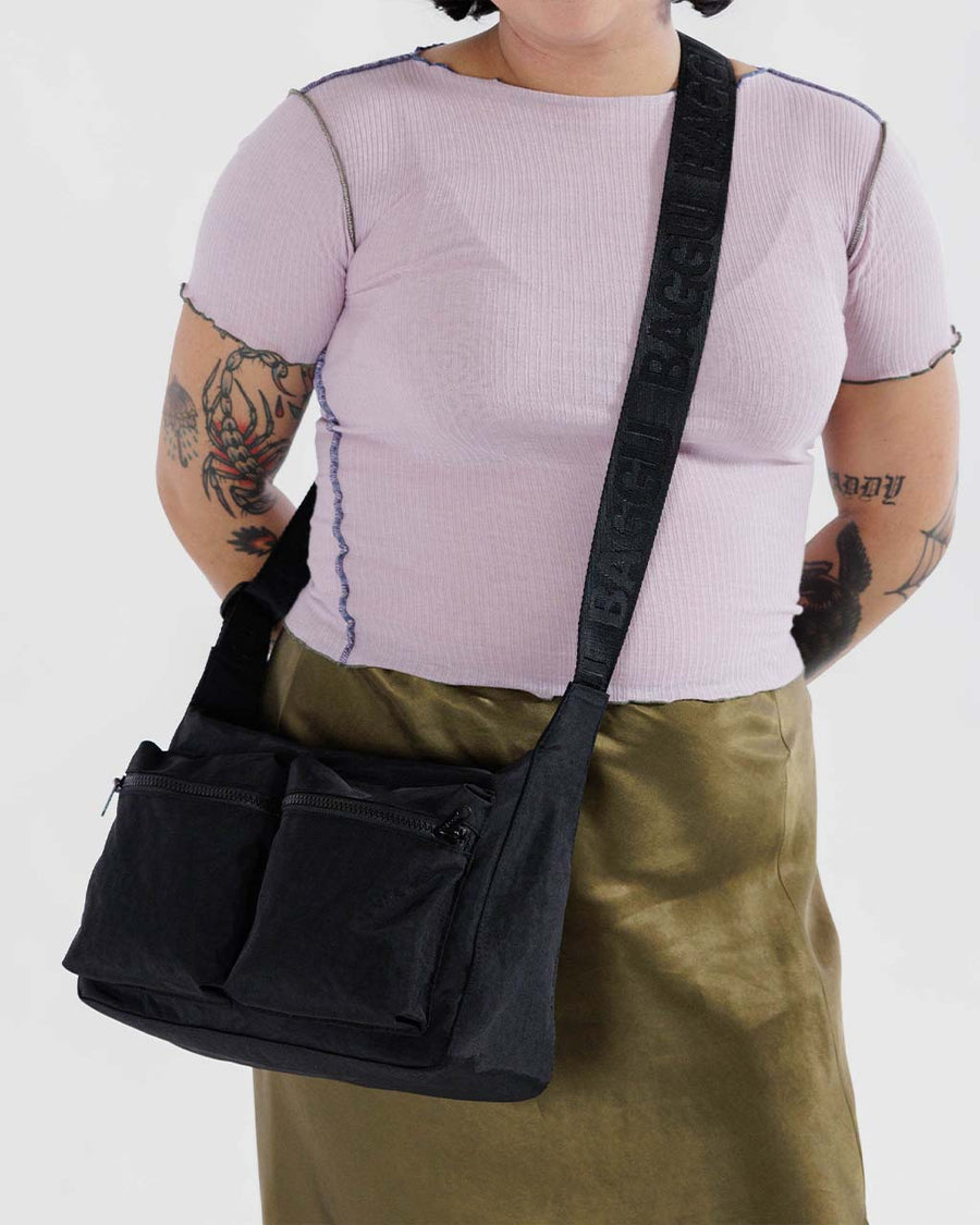 model wearing black medium cargo crossbody bag