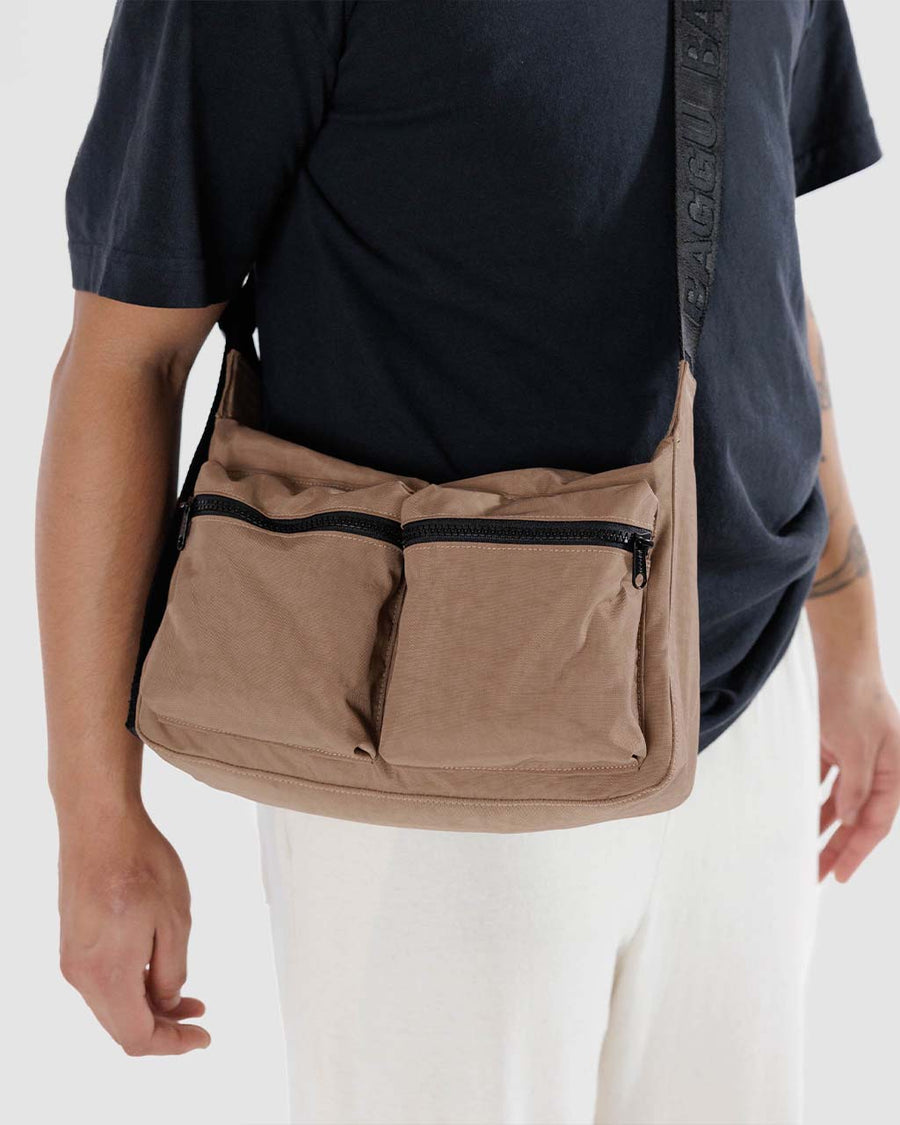 model wearing light brown medium cargo crossbody bag