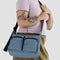model wearing digital blue medium cargo crossbody bag