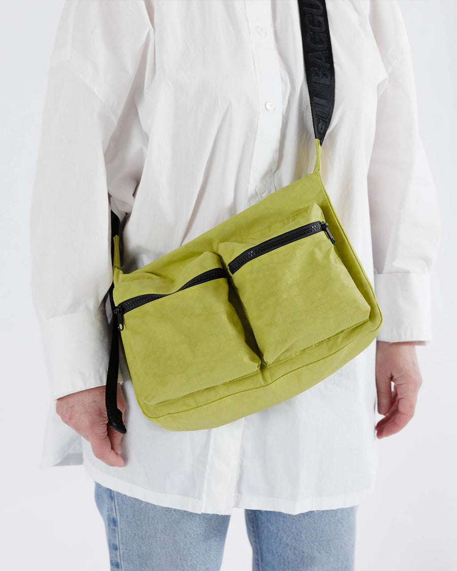 model wearing lime green medium cargo crossbody bag
