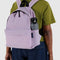 model wearing dusty pink backpack with black trim, two pouches with water bottle holder on the side