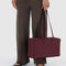 model holding mahogany rectangular bowler bag with bag charm clip