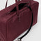 mahogany rectangular bowler bag with bag charm clip and black key leash inside