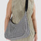 model wearing black and white gingham medium crescent bag