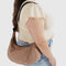model wearing light brown medium crescent bag