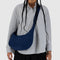 model carrying navy medium crescent bag with matching strap and zipper