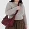 model carrying mahogany recycled leather medium crescent bag with matching strap and trim