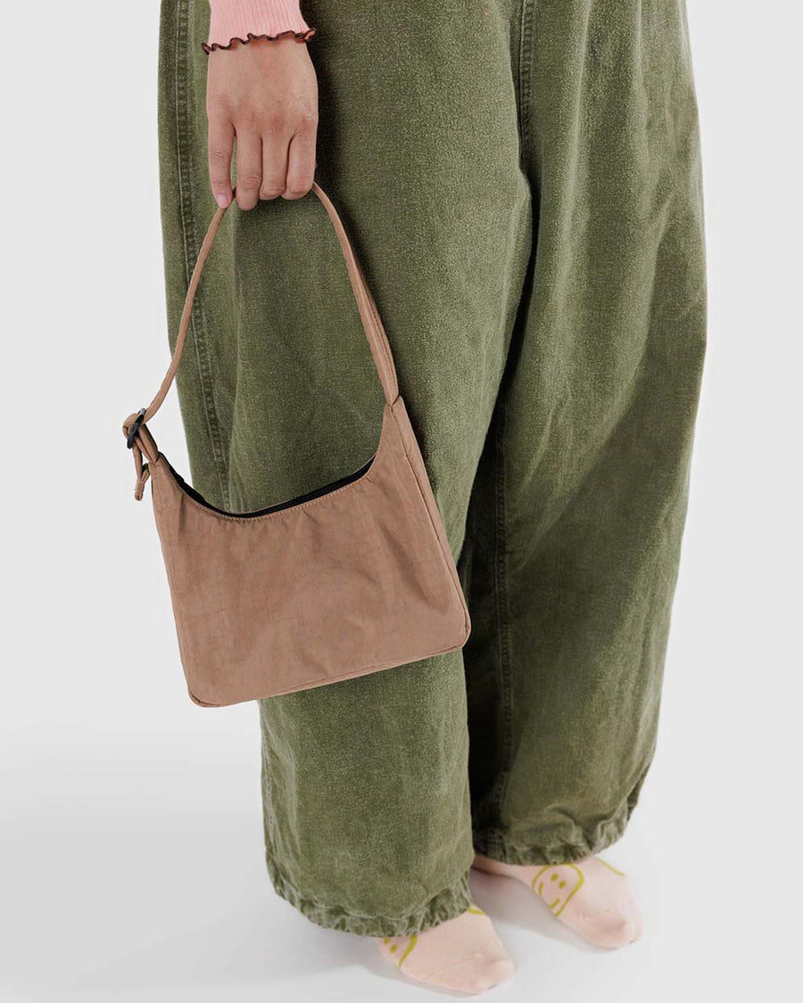 model holding light brown mini nylon shoulder bag