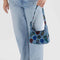 model holding digital denim mini nylon shoulder bag with colorful flower and bird print