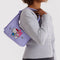 model carrying lavender mini nylon shoulder bag with embroidered hello kitty and my melody holding hands