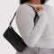 model carrying nylon pochette bag with smiley charm and adjustable shoulder strap