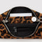 interior of nylon leopard pochette bag with smiley charm and adjustable shoulder strap