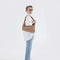 model carrying light brown nylon shoulder bag